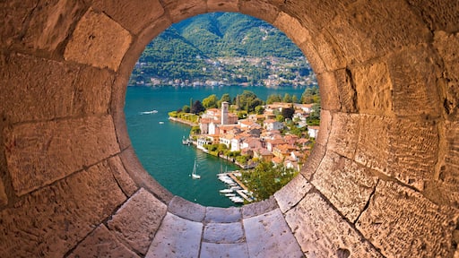 Idyllic town of Torno on Como lake view through stone window