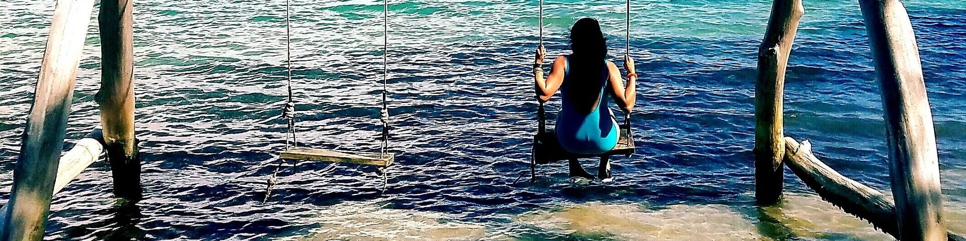 The best way to be a kid again! Swing on the beach at Sandy Bay in Jamaica. Ideal to watch horses swim in the gorgeous water! #beachbound