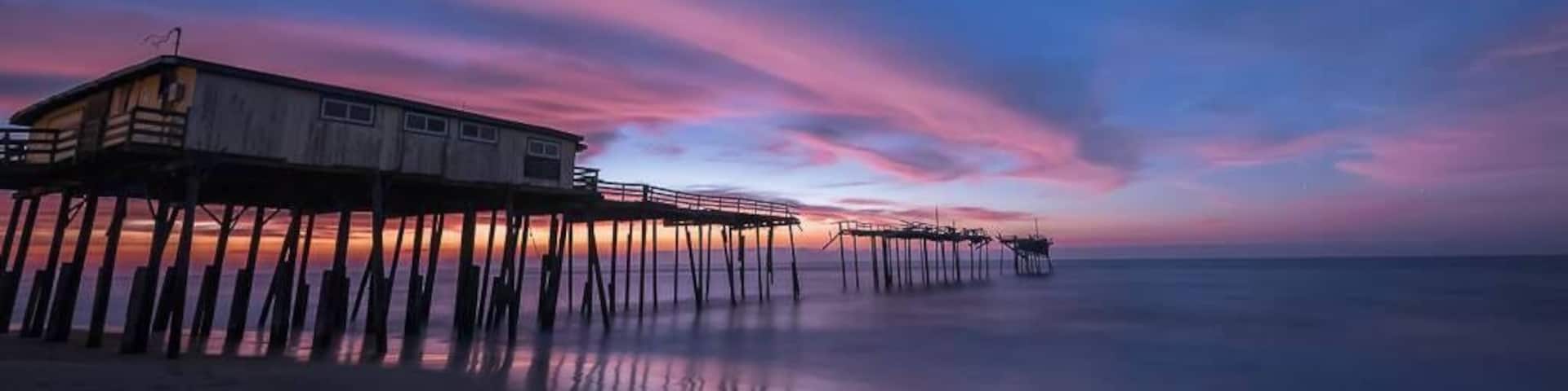 "Yin and Yang"
I was at Cape Hatteras last month to try and capture a sight of one of our heavenly visitors in the night sky - Comet Catalina. The comet is somewhat unique since this would be it's only ever visit to the inner Solar System before being ejected to interstellar space forever. It was by no means an easy target to locate and photograph in the night sky especially for someone who's never done that before.
But this is not about my attempts at capturing Comet Catalina (although I did manage to view and capture it). After I was done looking at the comet, I settled by the beach next to this pier, one of my favorite places on the North Carolina Outerbanks, to hear the ocean's mesmerizing soundtrack. I still had about 2 hours to go before sunrise and so I was just sitting and enjoying the unseasonably warm winter in December and just looking at the stars, Venus, Jupiter and Mars in the night sky. I suddenly noticed this big cloud about 5 minutes in streaking just below bright Venus. On a hunch, I decided to capture an image to see what the cloud looked like and a short 15 second later, I saw the start of what turned out to be one of the most perfect sunrises I have borne witness to. The cloud had started to just pick up the first rays from the sun, with about an hour and a half to go before sunrise.
I love the juxtaposition of every single element in this image. The fading of the night sky and stars with Venus shining valiantly as the sun comes back to herald the start of another day, the stretch of unbroken cloud over the hurricane damaged pier and the sheer beauty created in an otherwise damaging act of Mother Nature (the hurricane, not the sunrise :) ). This duality is what inspired the title of the image.
If you're near the NC coast, this location is a must stop. It is close to the town of Buxton and the Cape Hatteras Lighthouse.
Thank you for stopping by.
#colorful #goldenhour #hiking #weekend #roadtrip #waterlust #OBX #NC #USA #Pier #Frisco #CapeHatteras #abandoned #beach #beaches #blue #bestof5 #lovemytown