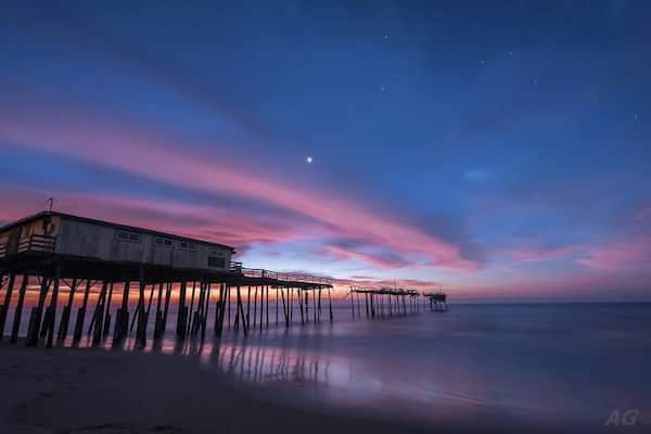 "Yin and Yang"
I was at Cape Hatteras last month to try and capture a sight of one of our heavenly visitors in the night sky - Comet Catalina. The comet is somewhat unique since this would be it's only ever visit to the inner Solar System before being ejected to interstellar space forever. It was by no means an easy target to locate and photograph in the night sky especially for someone who's never done that before.
But this is not about my attempts at capturing Comet Catalina (although I did manage to view and capture it). After I was done looking at the comet, I settled by the beach next to this pier, one of my favorite places on the North Carolina Outerbanks, to hear the ocean's mesmerizing soundtrack. I still had about 2 hours to go before sunrise and so I was just sitting and enjoying the unseasonably warm winter in December and just looking at the stars, Venus, Jupiter and Mars in the night sky. I suddenly noticed this big cloud about 5 minutes in streaking just below bright Venus. On a hunch, I decided to capture an image to see what the cloud looked like and a short 15 second later, I saw the start of what turned out to be one of the most perfect sunrises I have borne witness to. The cloud had started to just pick up the first rays from the sun, with about an hour and a half to go before sunrise.
I love the juxtaposition of every single element in this image. The fading of the night sky and stars with Venus shining valiantly as the sun comes back to herald the start of another day, the stretch of unbroken cloud over the hurricane damaged pier and the sheer beauty created in an otherwise damaging act of Mother Nature (the hurricane, not the sunrise :) ). This duality is what inspired the title of the image.
If you're near the NC coast, this location is a must stop. It is close to the town of Buxton and the Cape Hatteras Lighthouse.
Thank you for stopping by.
#colorful #goldenhour #hiking #weekend #roadtrip #waterlust #OBX #NC #USA #Pier #Frisco #CapeHatteras #abandoned #beach #beaches #blue #bestof5 #lovemytown
