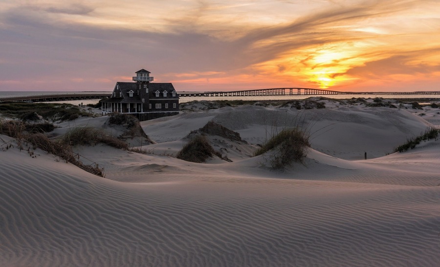 Bonner Bridge is one of North Carolina's most well known man-made structures of it's kind (The Linn Cove Viaduct on the Blue Ridge Parkway is probably the most well known). This location makes for a great getaway at the Outerbanks to spend an entire day (and night). The location is popular for fishing and is ideal for landscape and astro photography. You can have lots of fun on some of the dunes, although getting the sand out afterwards is a big hassle.
This is one of my favorite images from this location. I love the warm light tones and the shadows that create a contrast in the foreground sand. It is created from a single exposure with only minor modifications made to adjust overall contrast and brightness.
If you are interested in wildlife, the Pea Island Wildlife Refuge is nearby and is a very popular location.
Thank you for stopping by.
#NC #Sunset #Bridge #OBX #BonnerBridge #colorful #roadtrip #weekend #goldenhour #beaches #abandoned #USA #beach #history