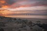 This image was captured at the Oregon Inlet on the NC Outerbanks in December of 2015. It features the iconic Bonner Bridge, one of the more famous bridges in North Carolina. This was an impromptu trip that I undertook hoping to catch a sight of Comet Catalina that was gracing our skies at the time. That trip turned out to be one of the best trips I have ever undertaken as I encountered perfect conditions for photography every single day over the 3 day period I was there.
This image is a blend of 2 images to bring out some detail in the foreground rocks. This composition appealed to me since the foreground rocks form a natural line to lead the viewer's eyes to the bridge and the clouds above. The clouds on this day were assuming various familiar shapes with the one captured here taking the shape of a bird in flight.
This particular stretch of the shoreline is very peaceful to walk along. Since it's an inlet, the waves are extremely calm unless it's windy. There are several sand dunes to the left of this image that ultimately would lead you to the proper coast and the ocean.
Update, 2020: This bridge is being dismantled and replaced with a newer bridge. Bonner Bridge has a lot of history tied to it and while it's sad to see it go, I feel fortunate to have captured part of this history personally.
Thank you for stopping by and for the support.
#sunset #nc #usa #bridge #obx #outerbanks #colorful #goldenhour #roadtrip #weekend #beach #beaches #bestof5 #nationalpark #bridges #lovemytown
#history #BeachBound