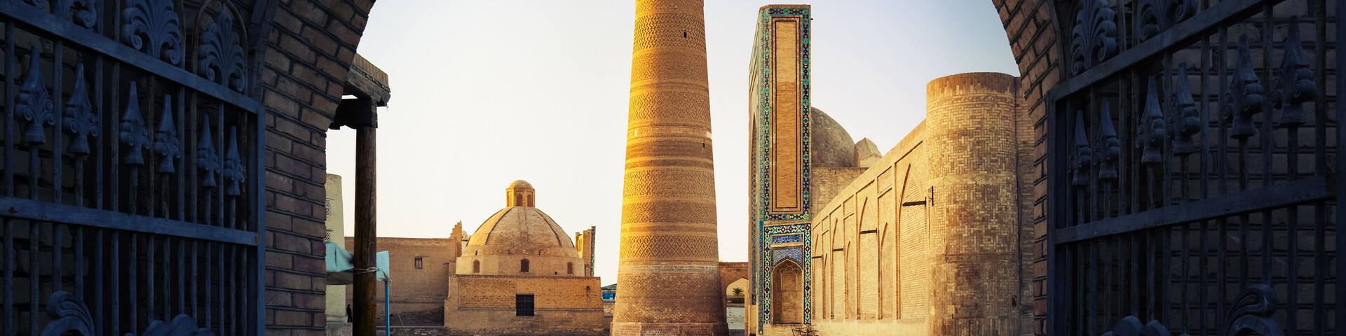 Yard of Poi Kalyan oriental complex at sunset. View from the gate. Bukhara, Uzbekistan