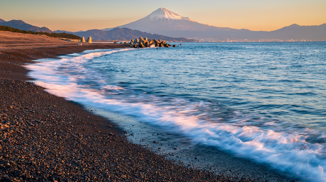 Mountain Fuji with wave crushing beach at sunrise view from Suruga Bay, Shizuoka, Japan