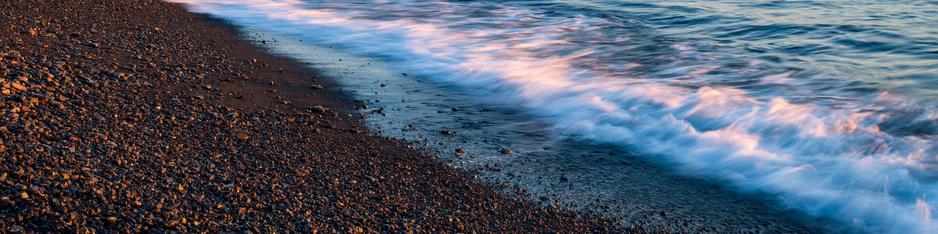Mountain Fuji with wave crushing beach at sunrise view from Suruga Bay, Shizuoka, Japan