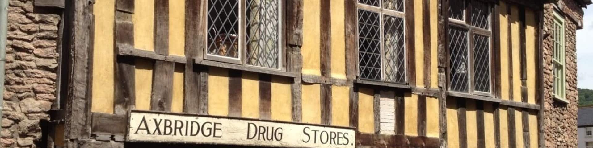A traditional half-timbered building with a sign reading "AXBRIDGE DRUG Stores."