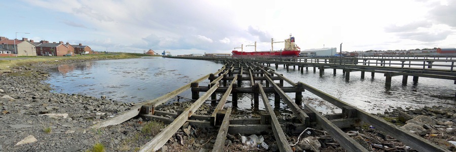 Old coal staithes, North Blyth. A panorama from the same location as 1452113. Another homage to one of the locations of the 1971 Michael Caine film, 'Get Carter' http://www.getcartertour.pwp.blueyonder.co.uk/getcarter/hordenstaithes.htm One of the red Alcan silos 37856 on the north shore of Blyth Harbour can be seen to the left of the docked ship - 'Cala Ponente' of Costa Container Lines 1425151. Another view of the staithes is here 1452850