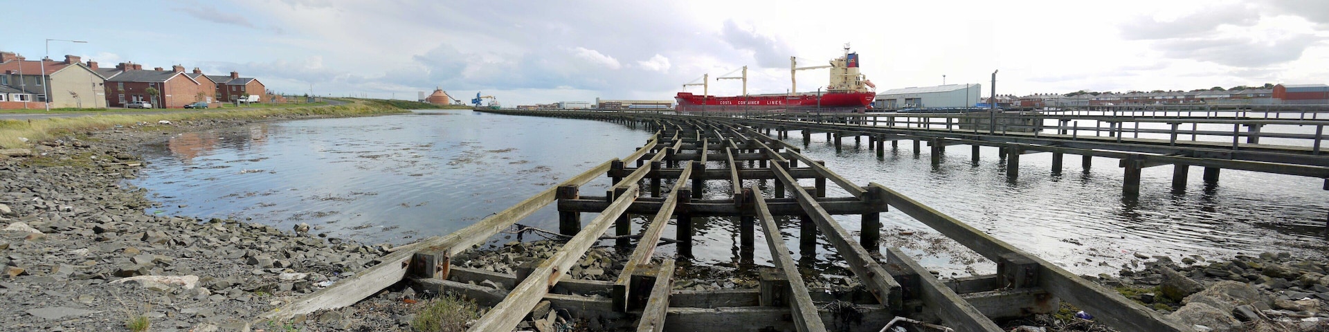 Old coal staithes, North Blyth. A panorama from the same location as 1452113. Another homage to one of the locations of the 1971 Michael Caine film, 'Get Carter' http://www.getcartertour.pwp.blueyonder.co.uk/getcarter/hordenstaithes.htm One of the red Alcan silos 37856 on the north shore of Blyth Harbour can be seen to the left of the docked ship - 'Cala Ponente' of Costa Container Lines 1425151. Another view of the staithes is here 1452850