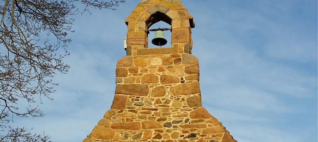 The sun hits St. Apoline's, a tiny chapel near Perelle in Guernsey.
