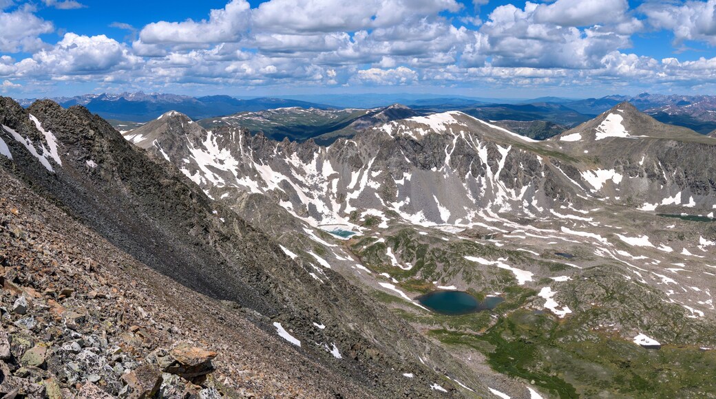 Summer Mountain Top - White clouds rolling over rugged mountain peaks and blue alpine lakes, as seen from summit of Quandary Peak looking towards northwest, on a sunny Summer day. Colorado, USA.