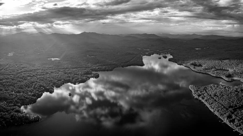 A mountainous landscape with a lake reflecting the sky.