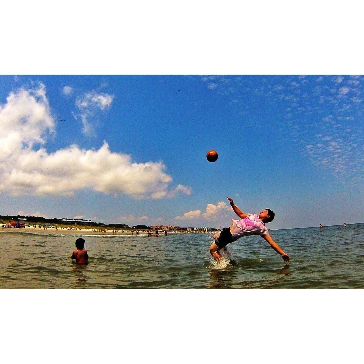Welcome to Burkes Beach... Hilton Head Island is known for its bike riding so this beach is easily accessible from the many bike baths along the way. The waves here are decent on a windy day the could get up to 8 foot waves at high tide. There's a sandbar that goes out at least 1/4 mile from the shore its crazy to be standing that far out. Do not get off the sand bar or you will attract the lifeguard. There is also a lagoon,  it's perfect to get out of the waves and a great inlet for fishing. As for the picture this is Juan Casanova from Ecuador. He currently lives in North Carolina with his family playing soccer on the weekends. On this particular day he was showing us his bicyclekick it was quite a show. I would highly recommend a vacation to Hilton Head.
 #soccer #beach