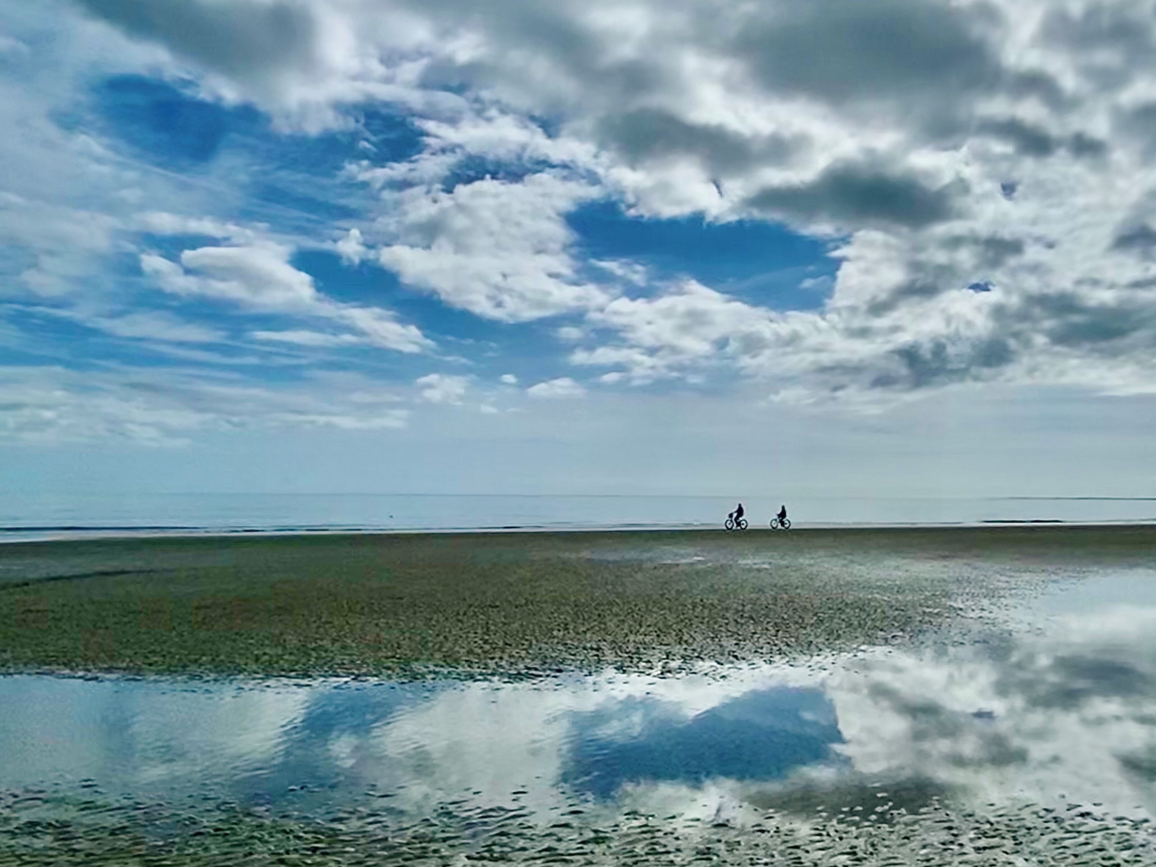 Beach bikers and tide pool reflections.