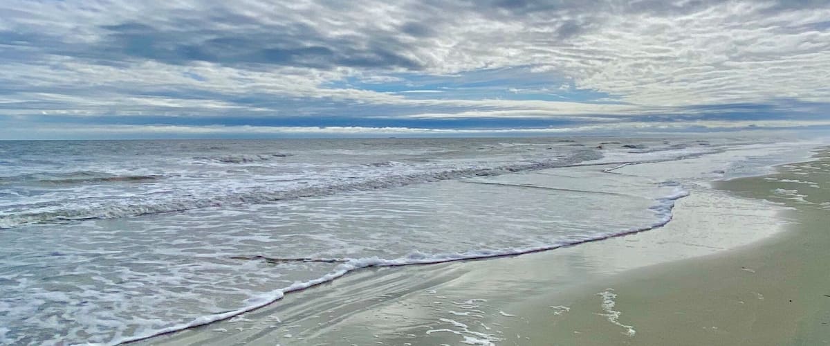 Clouds, surf and sand at Coligny Beach. 😎