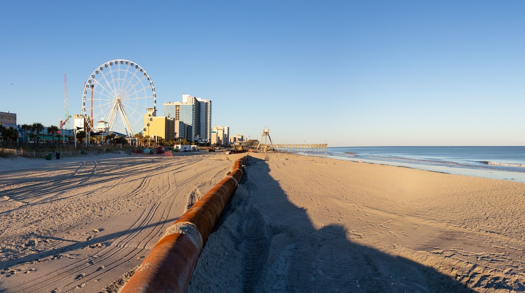 Myrtle Beach, South Carolina, United States - October 29, 2018: Old Rusty Pipes on the sandy beach during a sunny sunset.