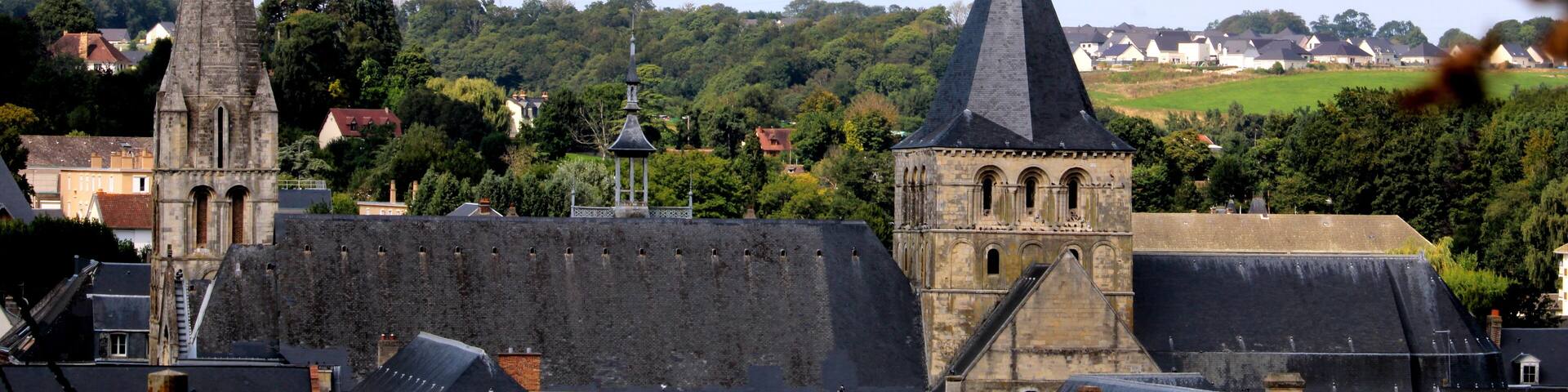 A town with prominent church spires and a castle-like structure.