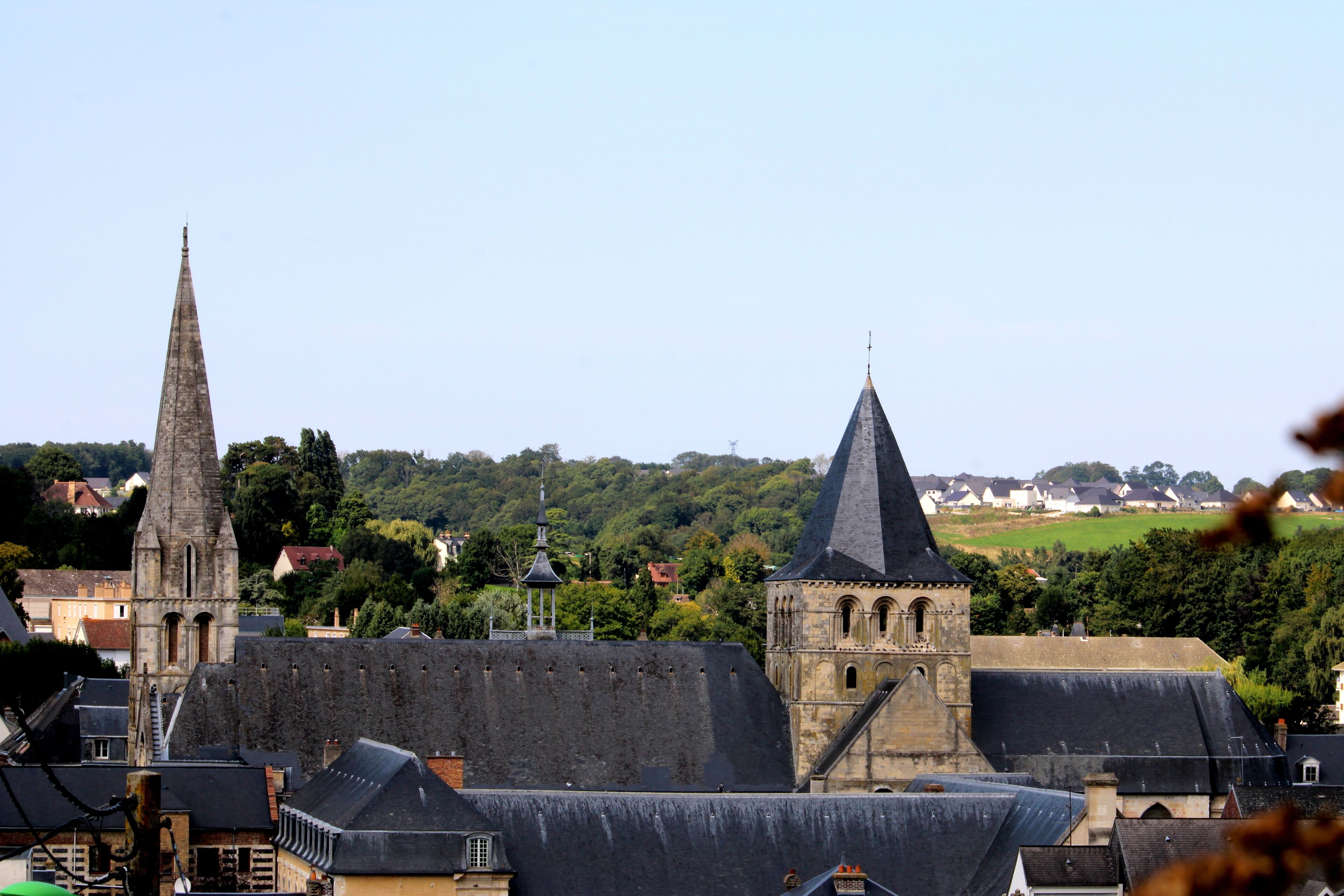 A town with prominent church spires and a castle-like structure.