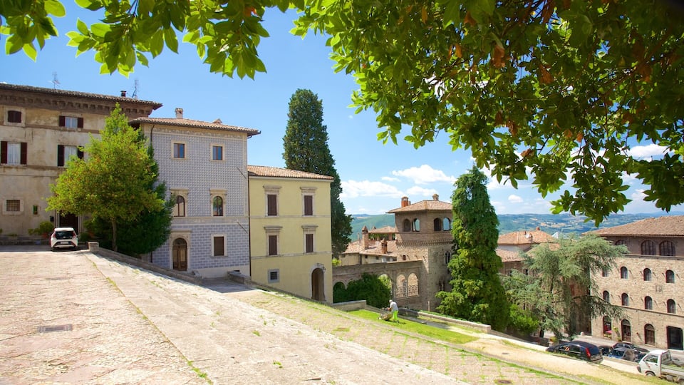 A historic town with cobblestone streets, traditional buildings, and a view of distant hills.