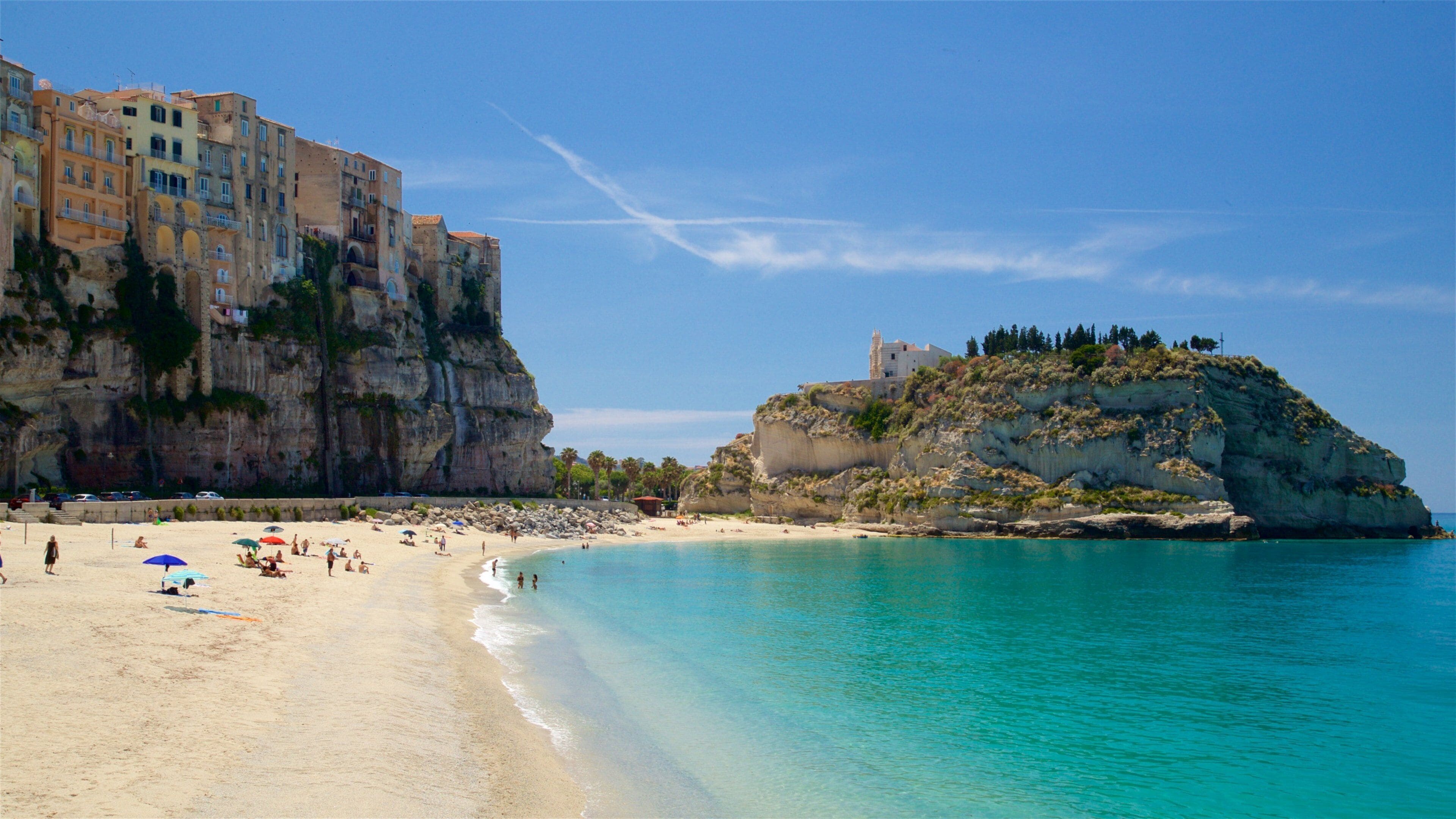 Tropea featuring rugged coastline, a beach and a coastal town