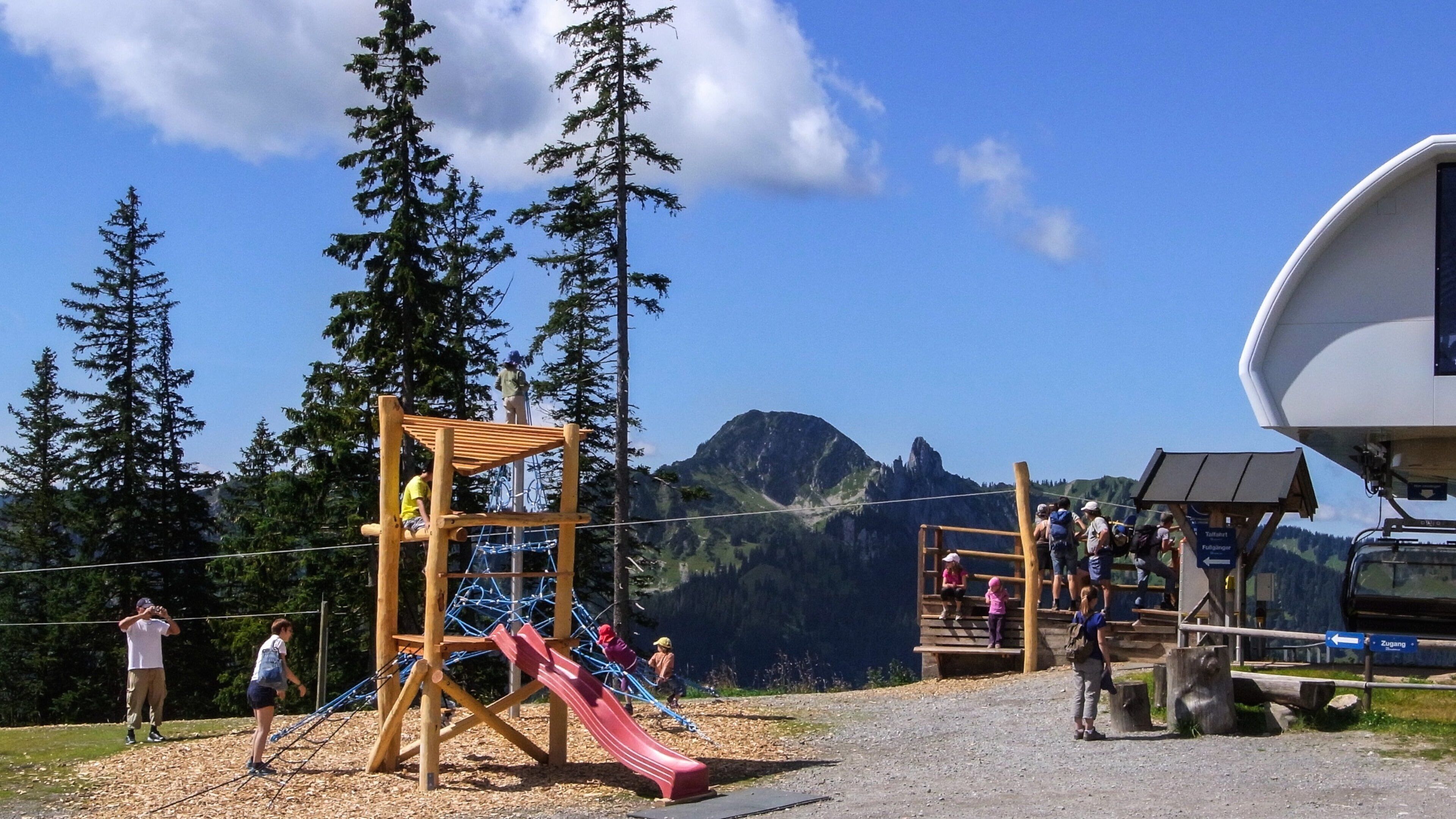 Spitzingsee featuring a playground as well as a family