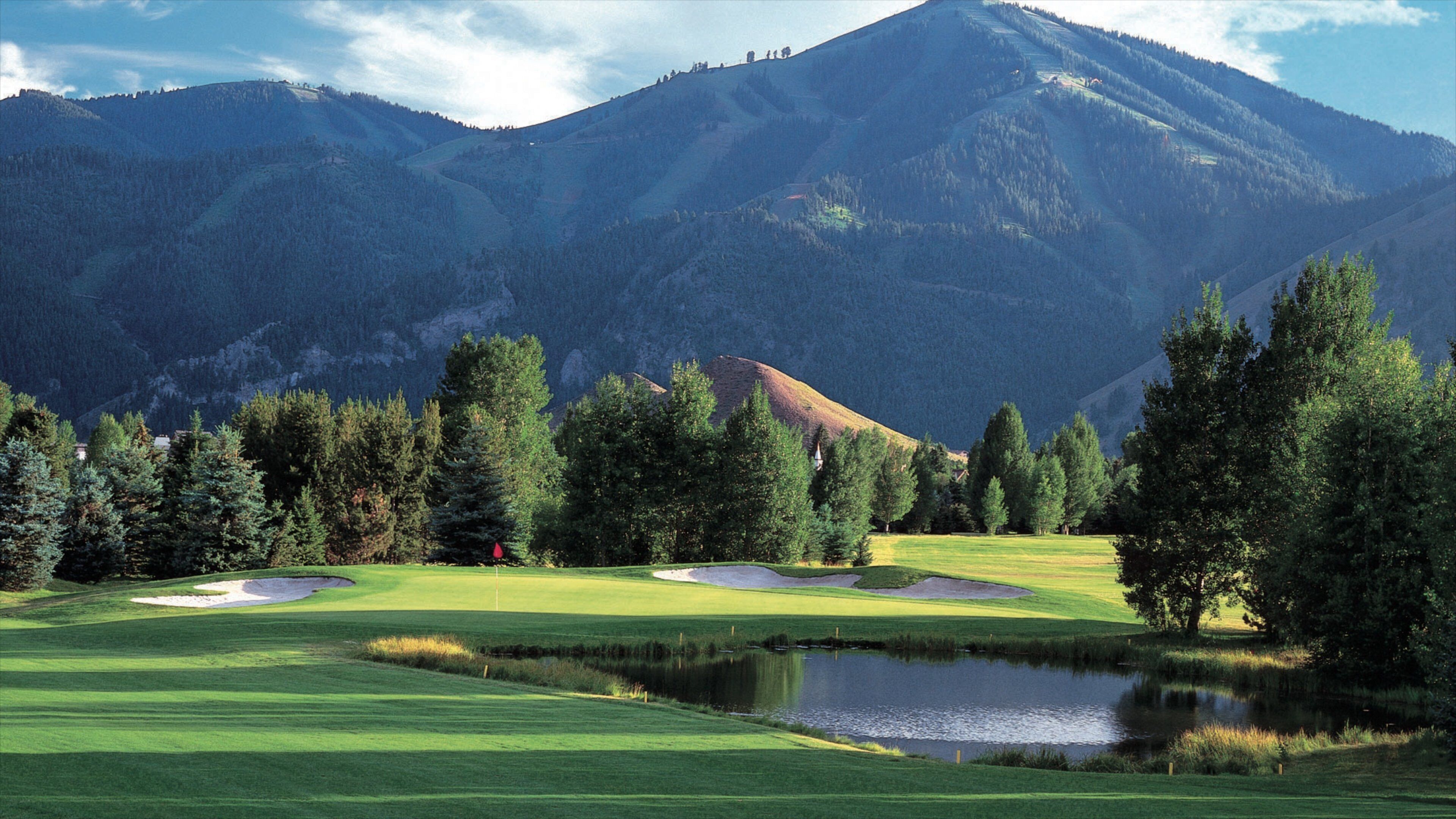 Sun Valley showing mountains, a pond and golf