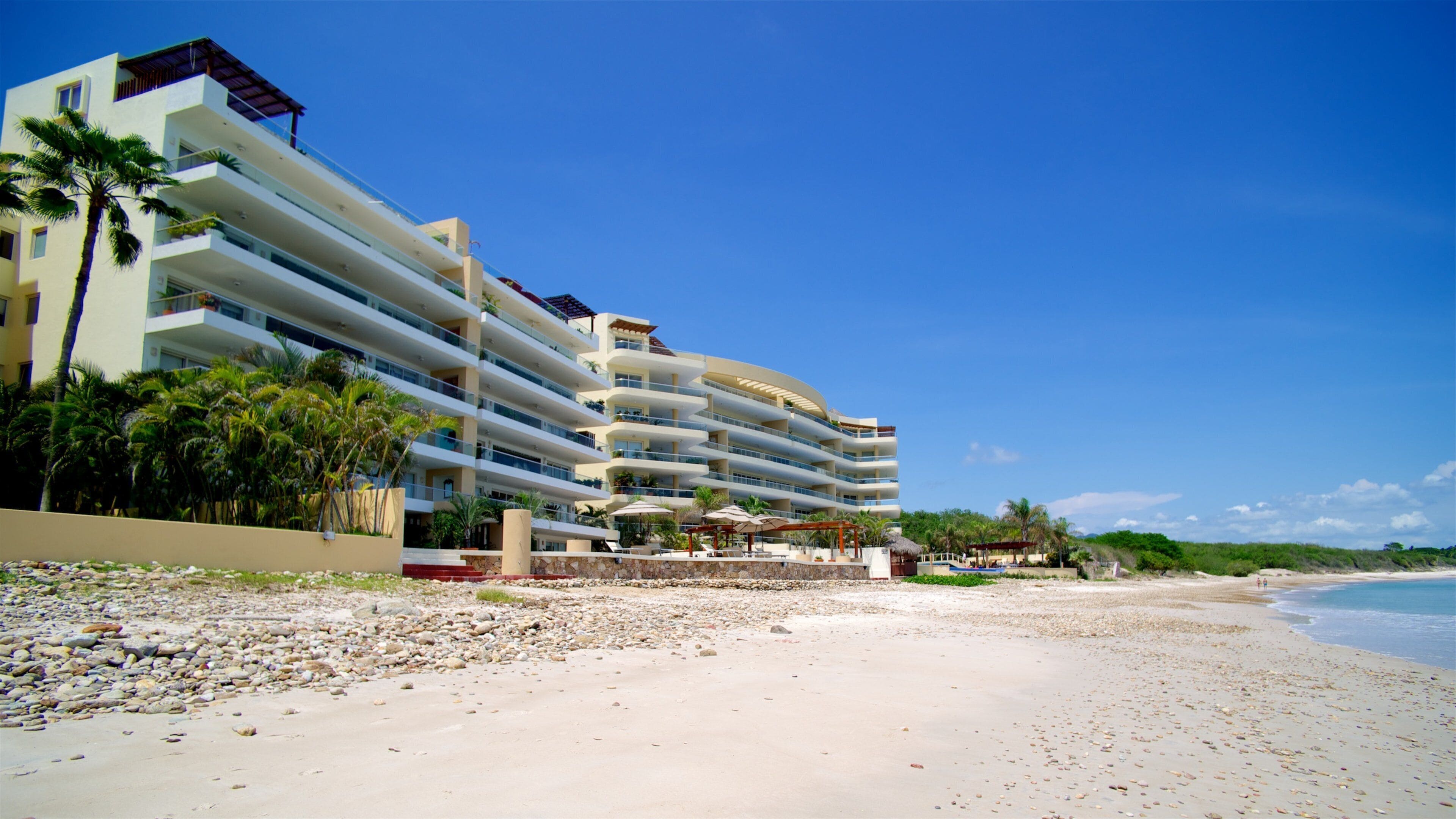 Mexico showing a sandy beach, a coastal town and a bay or harbor