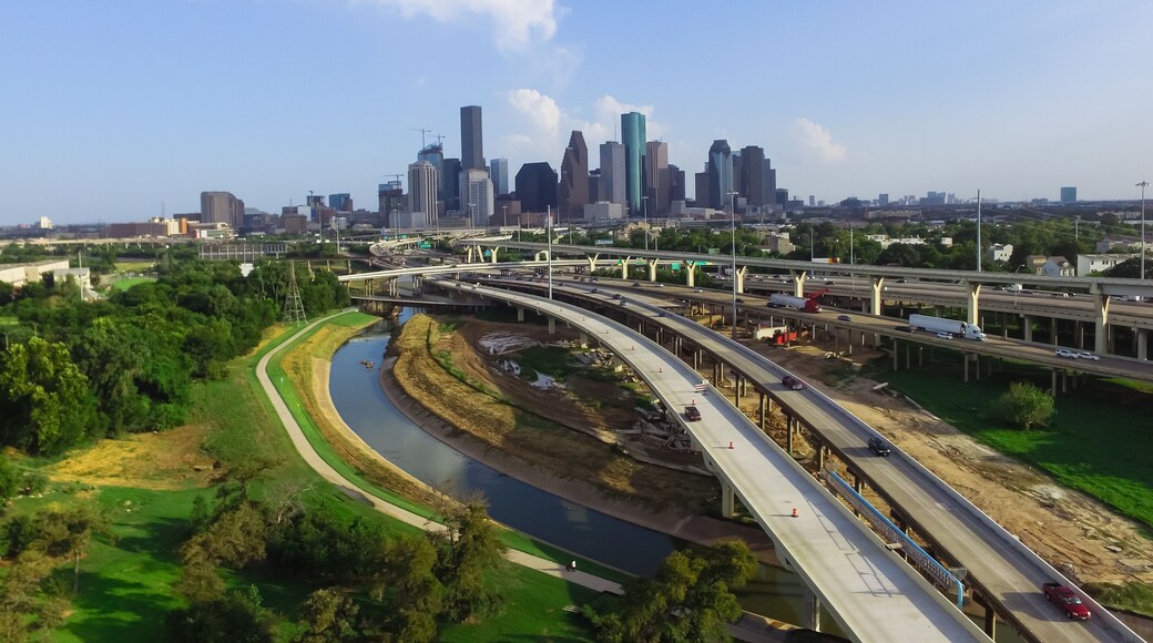 Aerial view downtown and interstate I45 highway with massive intersection, stack interchange, road junction overpass and elevated road construction at sunset from northwest side of Houston, Texas, USA