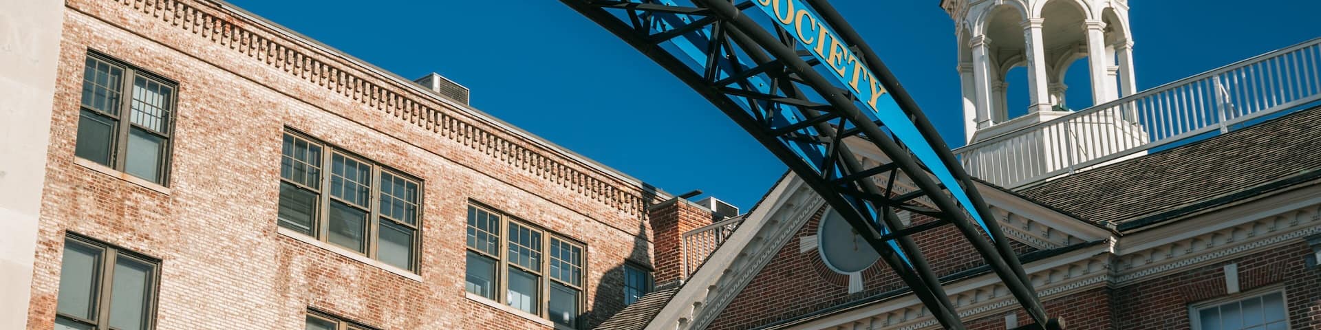 A blue archway with the text "Delaware Historical Society" against a clear blue sky.