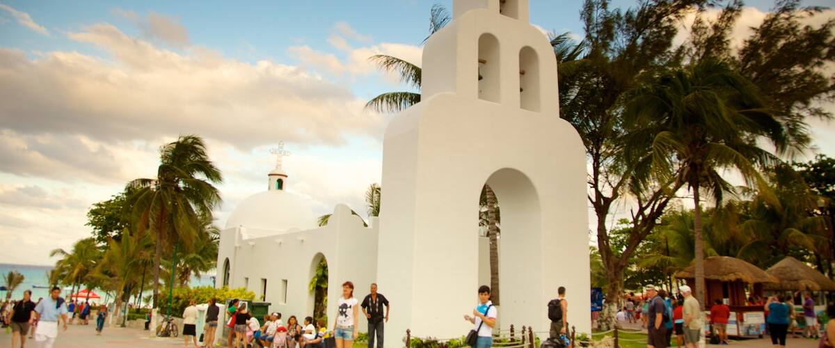 Playa del Carmen which includes religious elements and a sunset