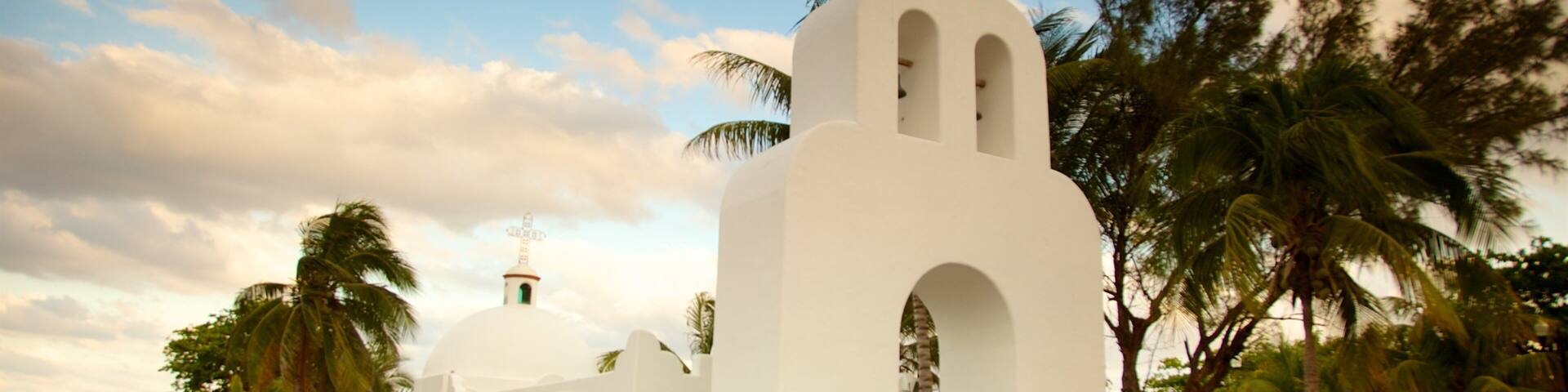 Playa del Carmen which includes religious elements and a sunset