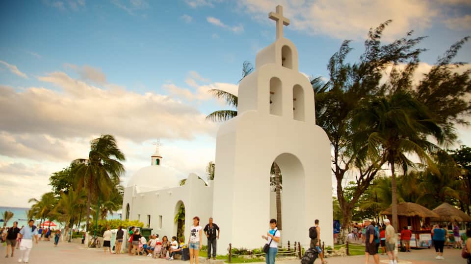 Playa del Carmen which includes religious elements and a sunset
