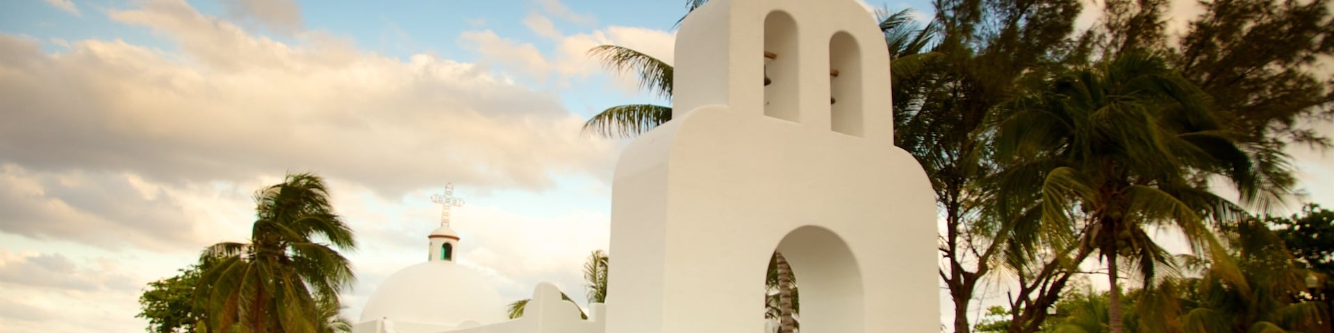 Playa del Carmen which includes religious elements and a sunset