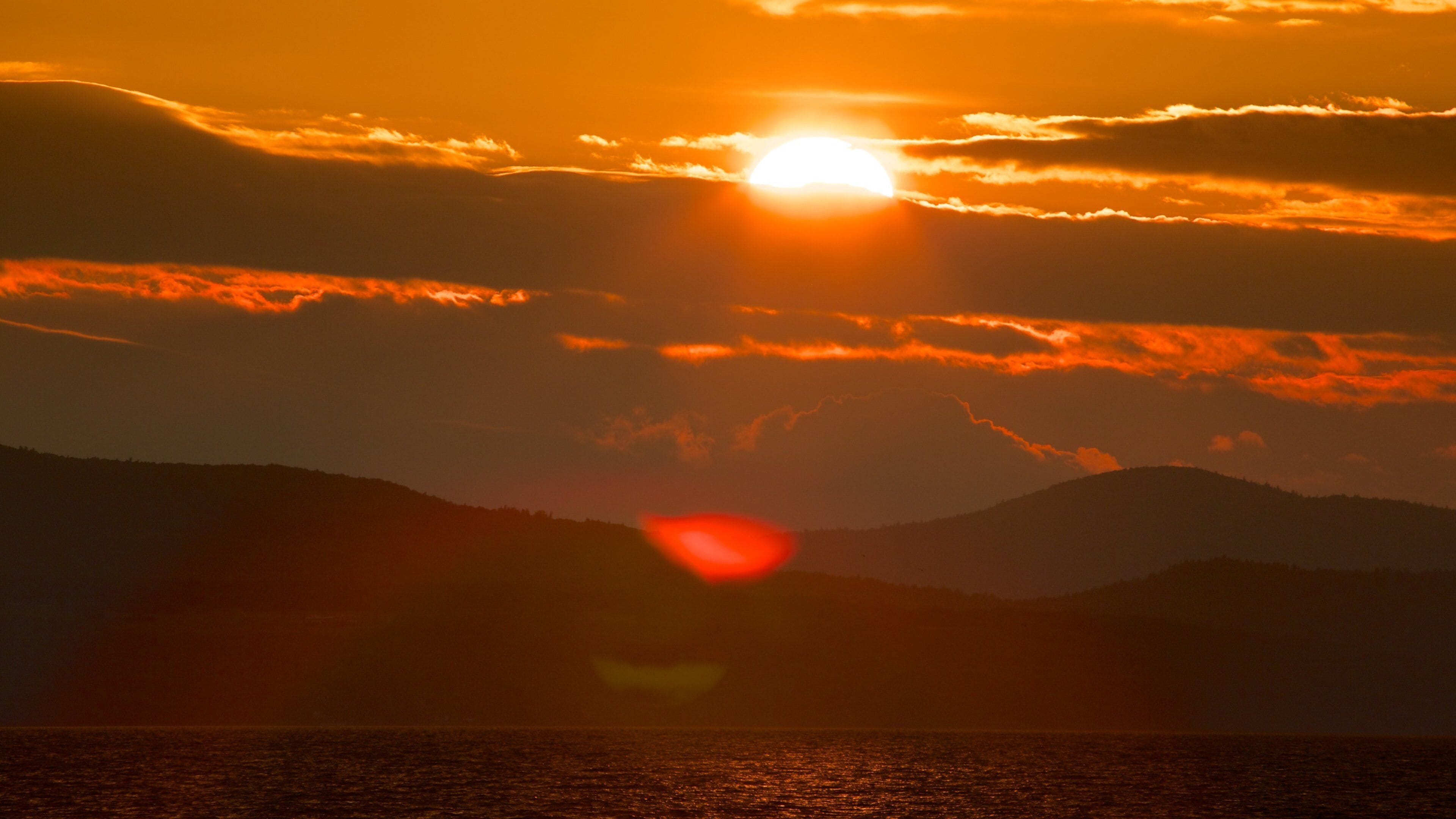 Burlington showing a sunset and a lake or waterhole