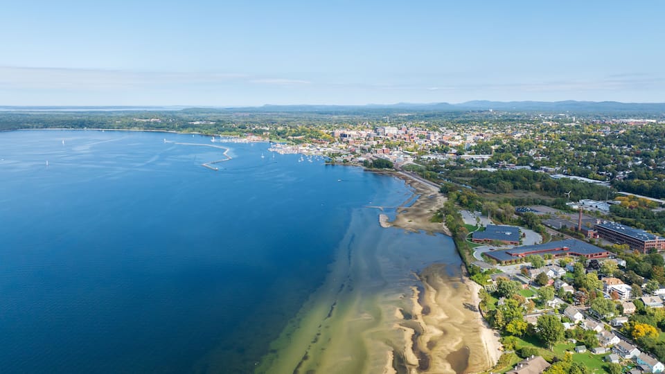 A coastal town with a marina, residential areas, and a large body of water.