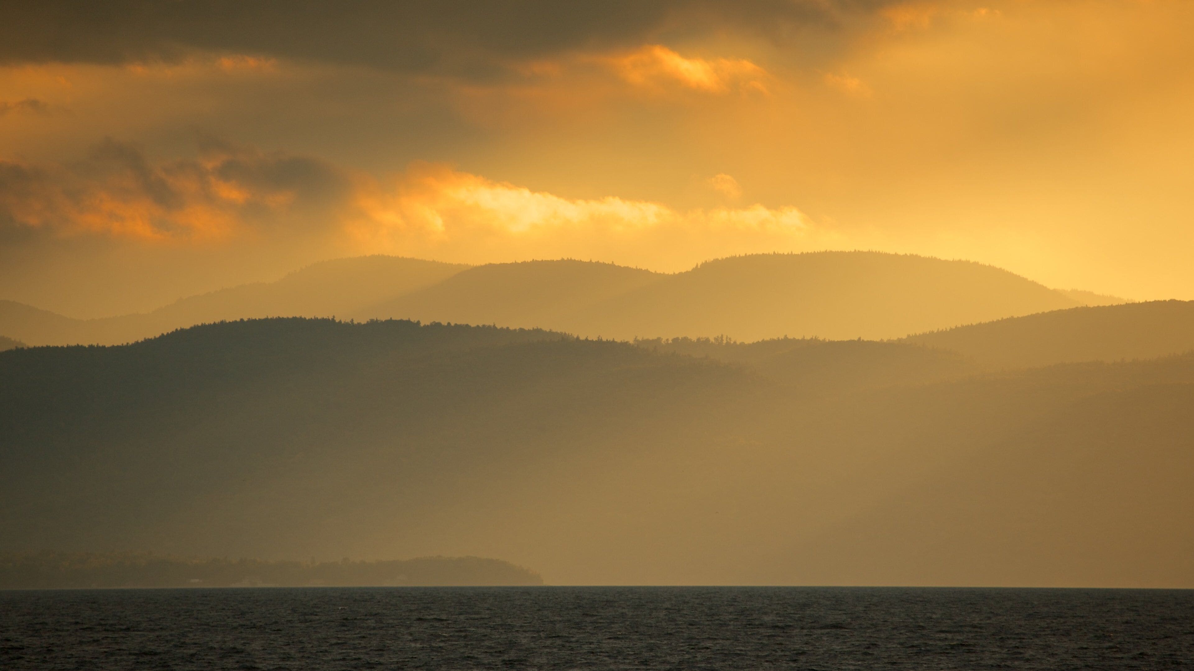 Burlington which includes a sunset and a lake or waterhole