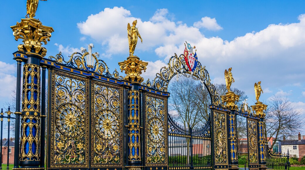 A golden ornate gate with statues and intricate designs.