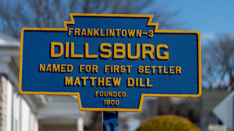 A blue and yellow historical marker sign for Dillsburg, named for first settler Matthew Dill, founded in 1800.
