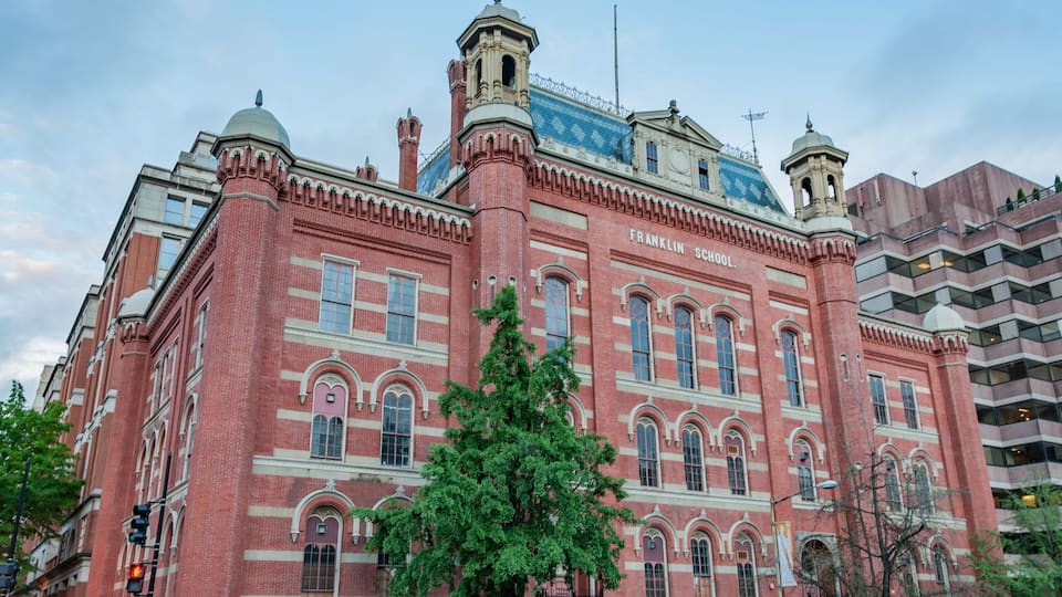 A historic red brick building with arched windows and a dome, labeled Franklin School.