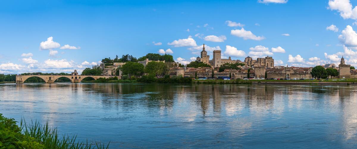 A historic city with a river, a bridge, and a prominent castle-like structure.