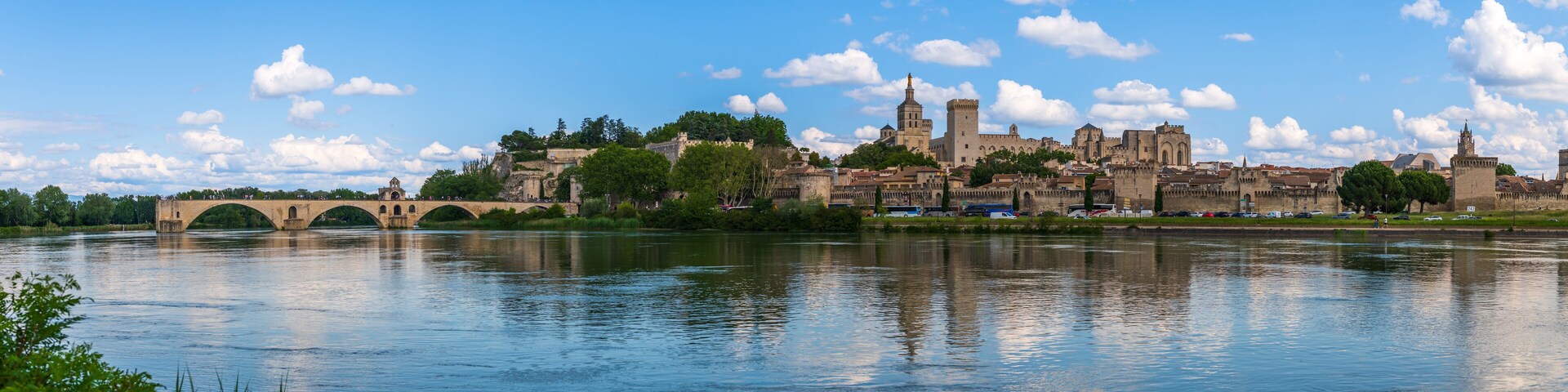 A historic city with a river, a bridge, and a prominent castle-like structure.