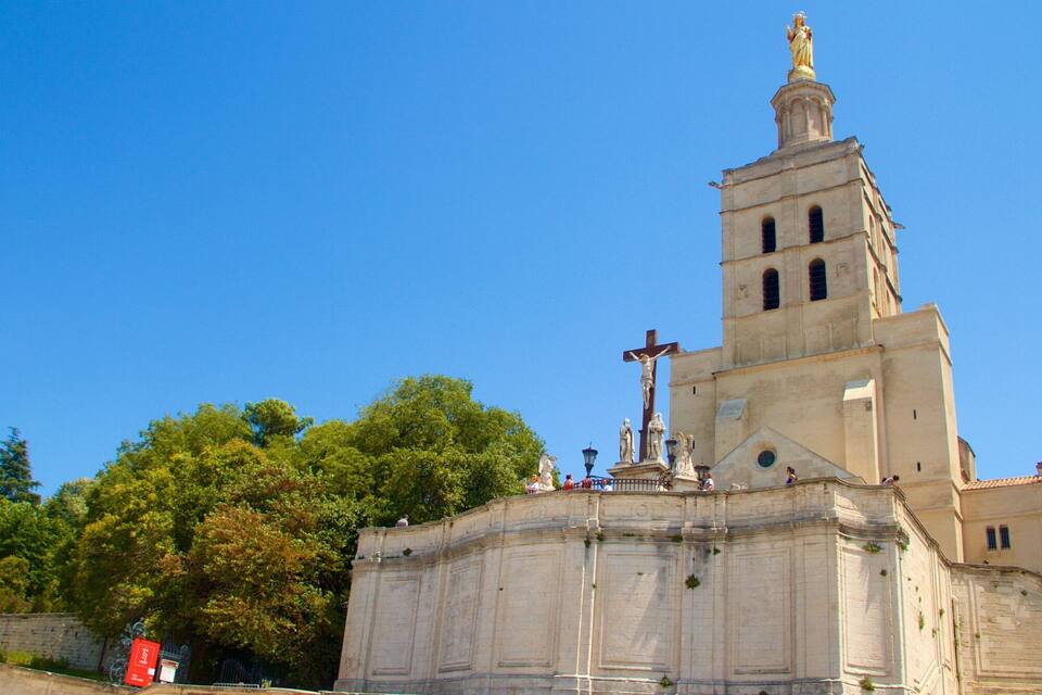 A church with a bell tower and a statue on top.