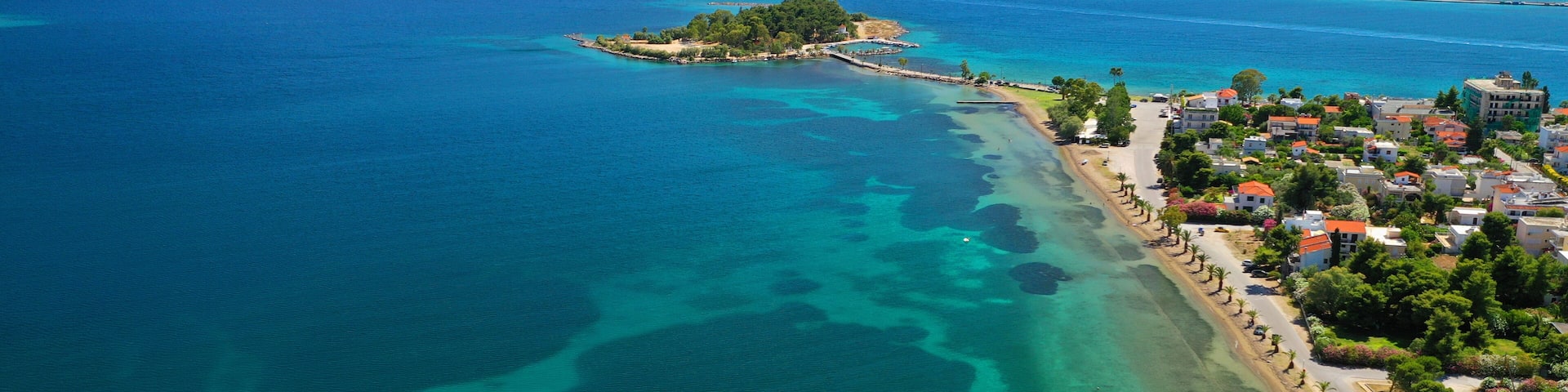 Aerial drone photo of famous island of dreams or Pesonisi connecting with small road with seaside fishing village of Eretria, Central Evia island, Greece