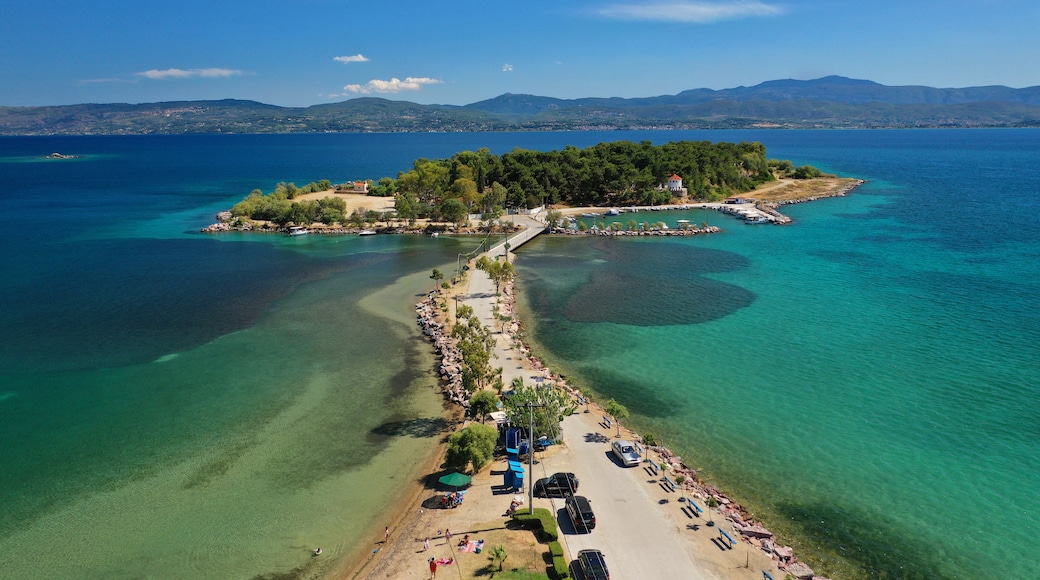 Aerial drone photo of famous island of dreams or Pesonisi connecting with small road with seaside fishing village of Eretria, Central Evia island, Greece