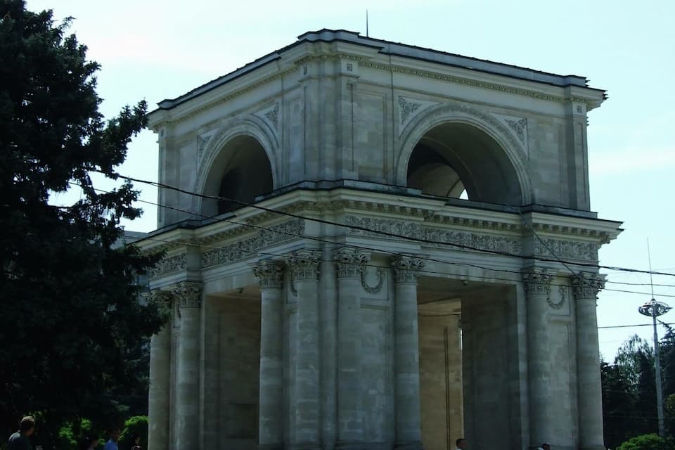 A neoclassical building with large columns and arched openings.