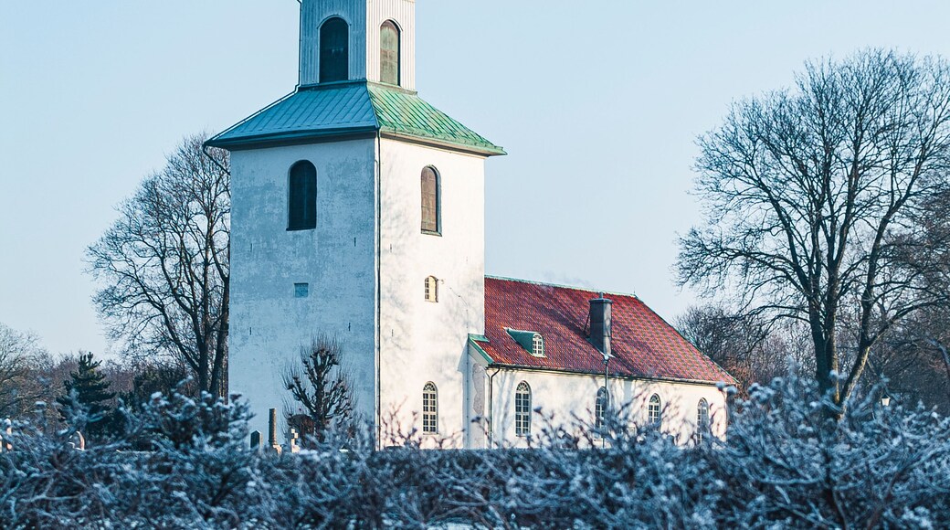 Beautiful winter view of the church in Landvetter, Sweden surrounded by frost-covered vegetation