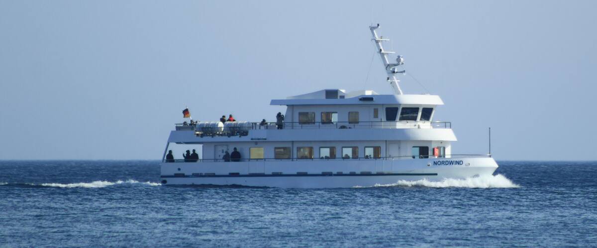 A white boat named 'Nordwind' on the ocean.