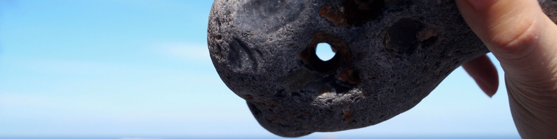 A HĂŒhnergott (adder stone also called "hag stone", "witch stone" or "serpent's egg" in English) is a stone with a naturally occurring hole through it. These stones can be found along RĂŒgen's Baltic Sea coast. They are said to have magical powers. We found a bunch of them below the Königsstuhl in the Jasmund National Park. Try your luck and try to find your own lucky charm!
