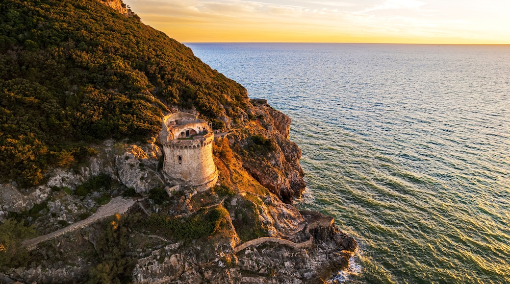 Medieval round tower standing on top of a cliff facing the sea at sunset, aerial shot, Sabaudia, Circeo National Park, Latina province, Latium, Lazio, Italy
