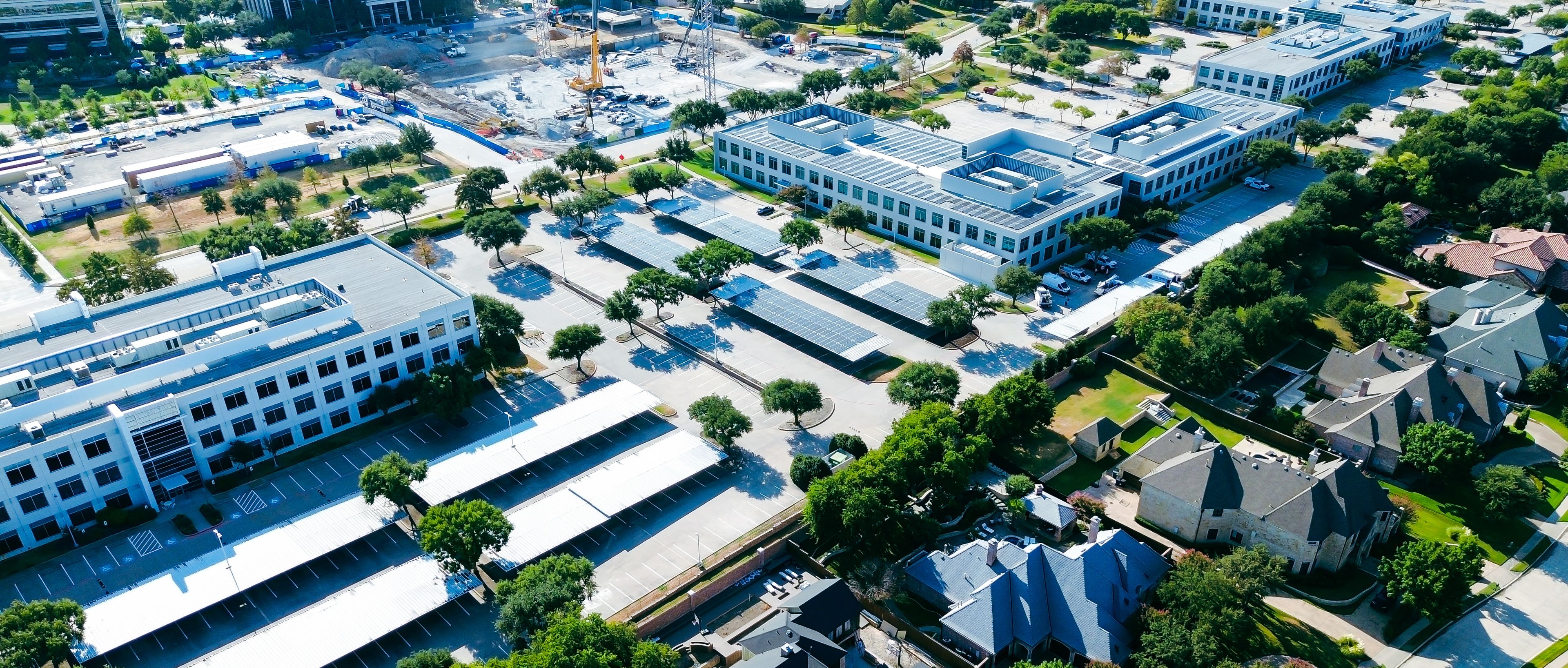Network Boulevard links multi-building corporate offices with expansive shaded parking rows. Commercial tech centers interface with tranquil luxury neighborhood borders, Frisco, Texas