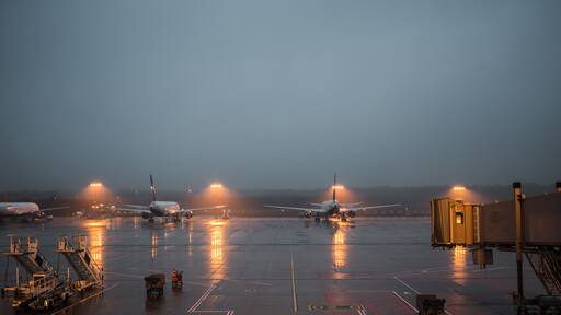 planes at the airport a foggy night